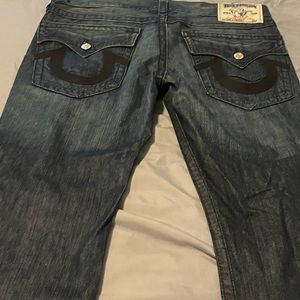 True religion denim brand jeans with black horse shoe and flap pockets